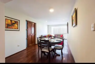 a living room with a dining room table and chairs at Apartamento en Miraflores in Lima