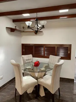 a dining room with a glass table and chairs at Apartamento Tumi Wasi in Lima