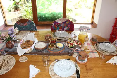 a wooden table with plates of food on it at Andean Spirit Lodge in Mollepata