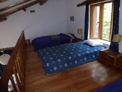 a bedroom with a bed and a window at Andean Spirit Lodge in Mollepata