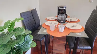 a table with plates and cups on top of it at Apartamento de 3 dormitorios frente a plaza San Miguel con Piscina in Lima