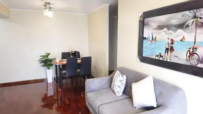 a living room with a couch and a picture on the wall at Apartamento de 3 dormitorios frente a plaza San Miguel con Piscina in Lima