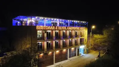 a building with a sign on it at night at Restobar & Hotel Campestre Aisha in Cocachacra