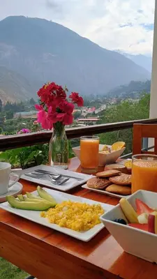 a table with a plate of breakfast food on it at Restobar & Hotel Campestre Aisha in Cocachacra