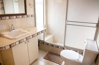 a bathroom with a toilet and a sink and a shower at The film House in Lima
