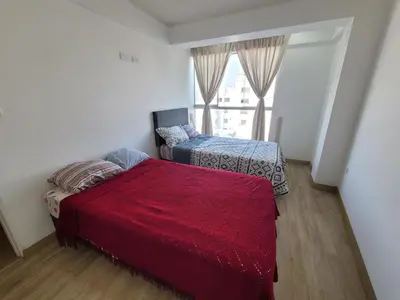 a bedroom with two beds and a window at 1cuarto 2 camas baño privado in Lima