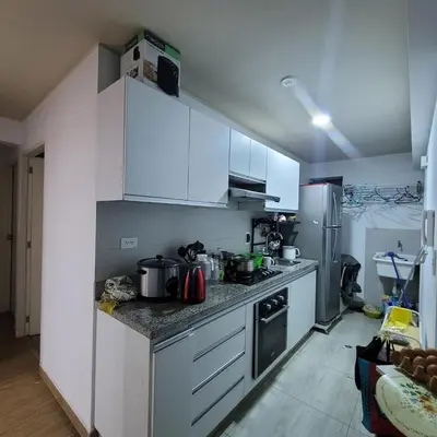 a kitchen with white cabinets and stainless steel appliances at 1cuarto 2 camas baño privado in Lima