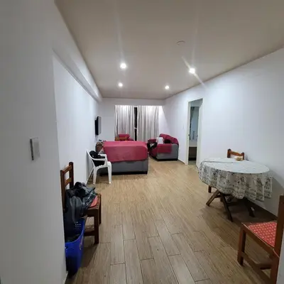 a living room with a bed and a table at 1cuarto 2 camas baño privado in Lima