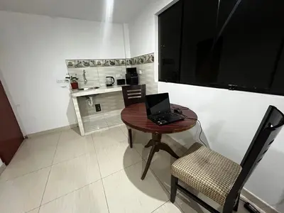 a small table with a laptop on it in a kitchen at Departamento Centro Histórico in Ayacucho