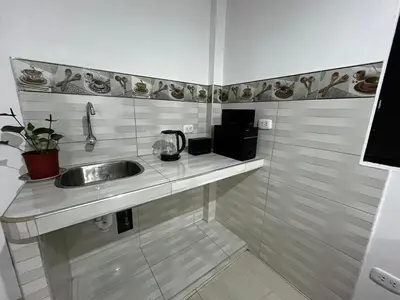 a bathroom with a sink and a microwave at Departamento Centro Histórico in Ayacucho