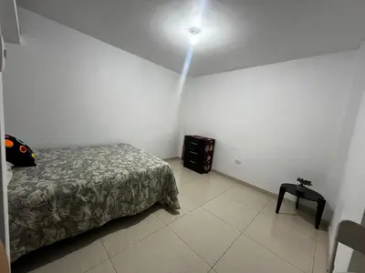 a bedroom with a bed and a light on the ceiling at Departamento Centro Histórico in Ayacucho