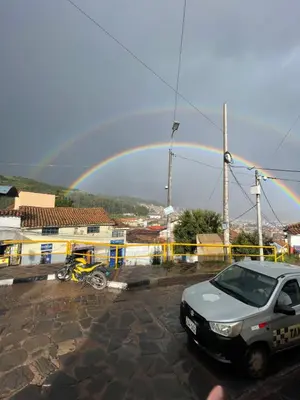 a rainbow over a parking lot with a car at Casa Secretos in Cusco