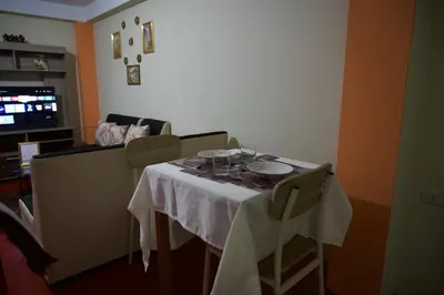 a dining room table with a white table cloth on it at Casa Secretos in Cusco