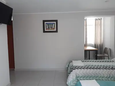 a hotel room with two beds and a window at Casa El Valle de Lunahuaná in Lunahuaná