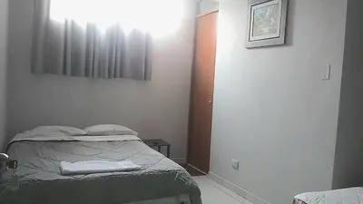 a small bedroom with a bed and a window at Casa El Valle de Lunahuaná in Lunahuaná