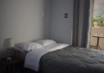 a bedroom with a bed with pillows and a window at Casa El Valle de Lunahuaná in Lunahuaná