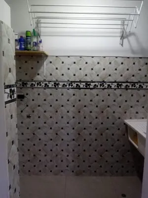 a bathroom with a shower with a tile wall at Departamento en Centro de Lima - Santa Beatriz in Lima