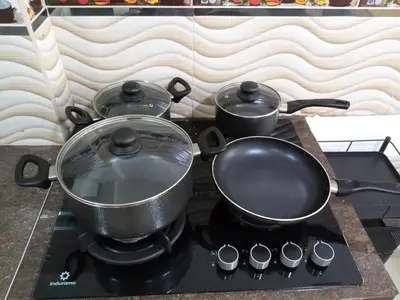 two pots and pans sitting on top of a stove at Departamento en Centro de Lima - Santa Beatriz in Lima