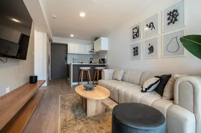 a living room with a couch and a table at 28 de Julio by Geko in Lima