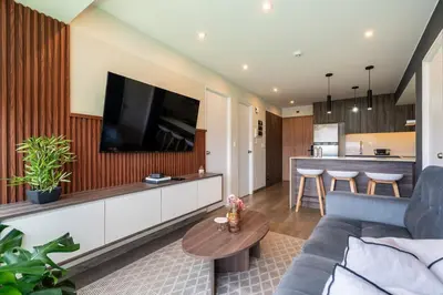 a living room with a couch and a tv at Plaza 27 by Geko in Lima