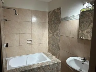 a bathroom with a bath tub and a sink at Apartment - US Embassy in Lima