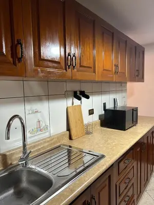 a kitchen with a sink and a microwave at Apartment - US Embassy in Lima