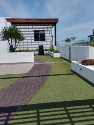 a backyard with a brick walkway and grass at Panoramic Elegante departamento in Lima