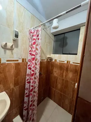 a bathroom with a shower curtain and a sink at Habitación con baño privado in Ayacucho