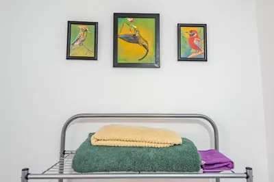 a shelf with a pillow and three pictures on a wall at Alojamiento en Centro Histórico Cusco in Cusco