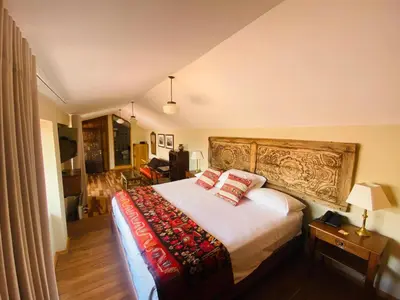 a bedroom with a large bed with two pillows at Artinka Boutique Hotel in Cusco