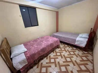 a room with two beds and a window at Habitación 2 camas in Ayacucho