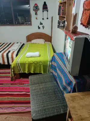 a bedroom with a bed and a tv on a table at Sanblas House in Cusco