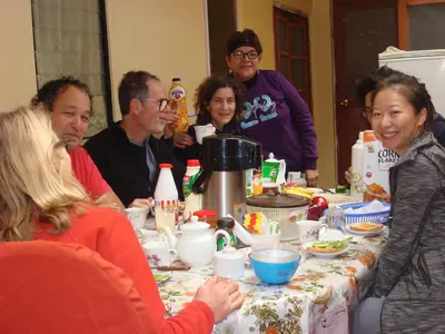 a group of people sitting around a table at Naty's Guest House in Cusco