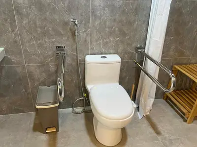 a bathroom with a toilet and a trash can at Albano Casa en bosque de conservación privado in Oxapampa