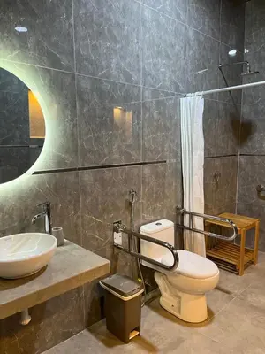 a bathroom with a toilet and a sink and a shower at Albano Casa en bosque de conservación privado in Oxapampa