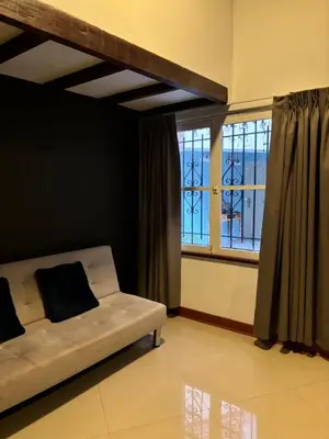 a living room with a couch and a window at Serendipia Studio Loft in San Isidro 205 in Lima