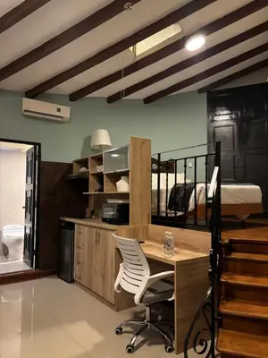 a bedroom with a desk and a bunk bed at Serendipia Studio Loft in San Isidro 205 in Lima