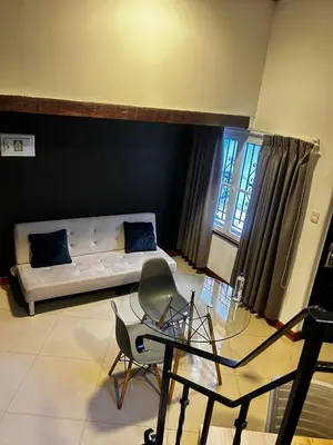 a living room with a couch and a glass table at Serendipia Studio Loft in San Isidro 205 in Lima