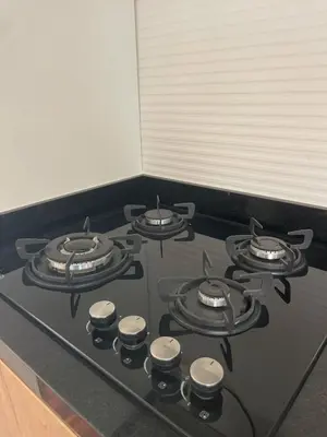 a stove top with four burners on it in a kitchen at Brand new modern apartment in Lima