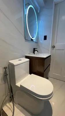 a bathroom with a white toilet and a sink at Brand new modern apartment in Lima