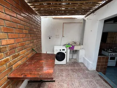 a room with a brick wall with a bench and a sink at Playa El Silencio House Facing the Sea in Bombiso