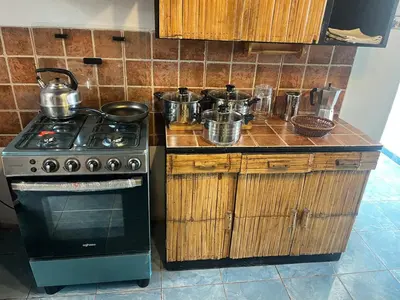 a kitchen with a stove and some pots and pans at Playa El Silencio House Facing the Sea in Bombiso