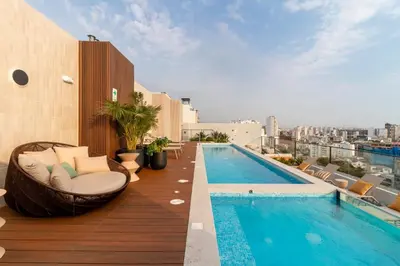 a balcony with a swimming pool on top of a building at Apartamento en Miraflores in Lima
