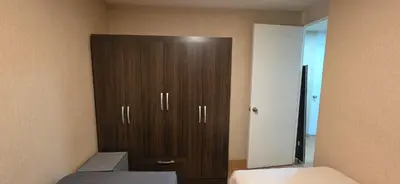 a bedroom with a large brown cabinet in the corner at Departamento 3 Dormitorios en Ñaña - Con Cochera in Chosica