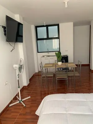 a bedroom with a bed and a table and chairs at Minidepartamentos Amoblado I en Estreno in Ica