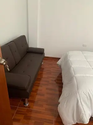 a couch and a pillow in a room at Minidepartamentos Amoblado III en Estreno in Ica