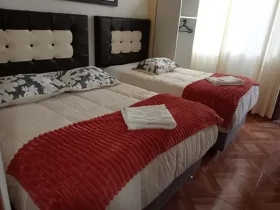 a bedroom with two beds with towels on them at Apartamento familiar 9 personas tranporte incluido in Cusco
