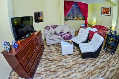 a living room with a flat screen tv and furniture at Matryoshka in Ica