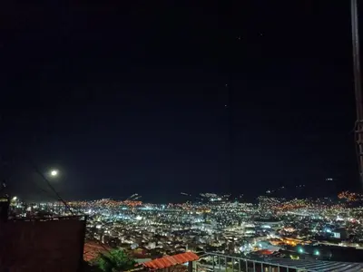 a view of a city lit up at night at San Blas House in Cusco