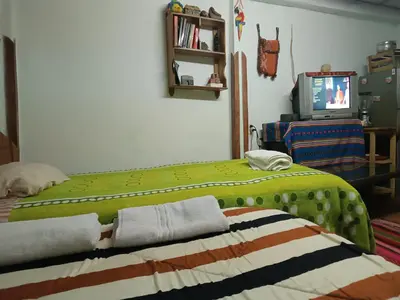 a bedroom with two beds and a tv in it at San Blas House in Cusco